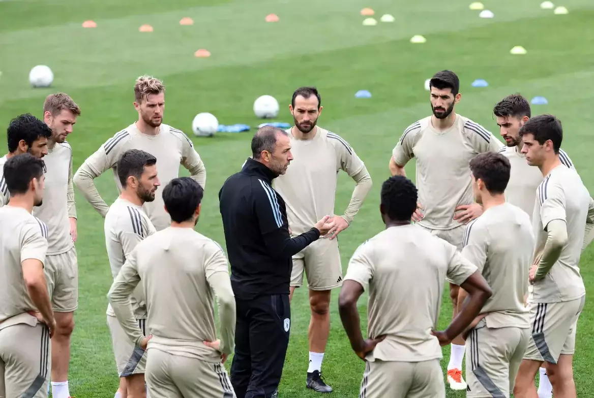 Fußballmannschaft bei einer Taktikbesprechung auf dem Spielfeld
