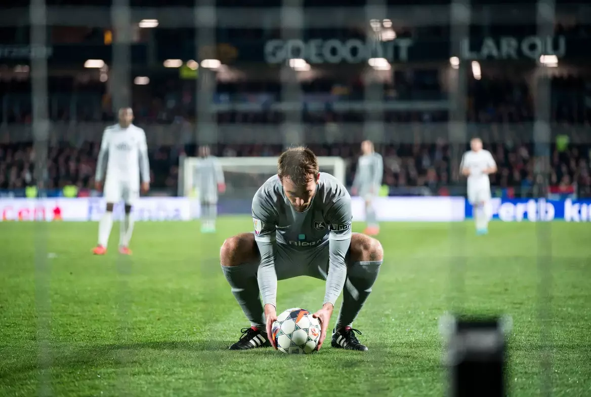 Fußballspieler positioniert sich für einen Freistoß